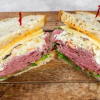 The New Yorker · Corned beef, pastrami, swiss, and coleslaw on rye with Russian dressing, lettuce, and tomato...