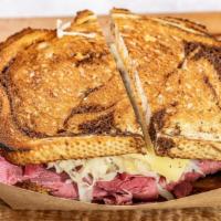 Reuben · Hot corned beef with swiss cheese and sauerkraut on rye toast with Russian dressing.