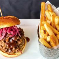 Texas-Style Chopped Beef Brisket Sandwich · Each potato bun sandwich is stacked with a heaping pile of tender, chopped brisket, pickled ...