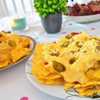 Xl Movie Nachos · Ground beef with hot melted cheese on tortilla chips.
