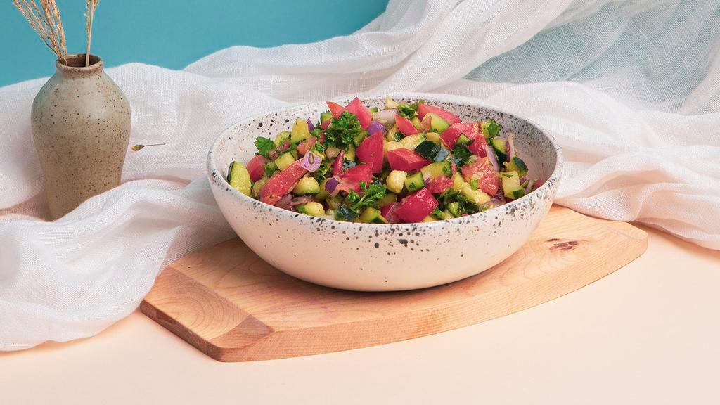 Israeli Salad · Fresh diced tomato, cucumber, and parsley with olive oil.