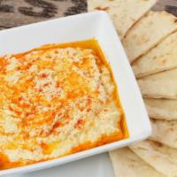 Hummus · Dip made from chickpeas sided with pita bread.