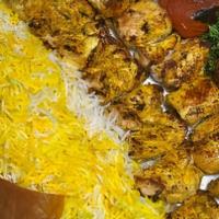 Chicken Kebab Plate · Skewer of marinated grilled chicken. Basmati rice topped with saffron. Sided with grilled to...