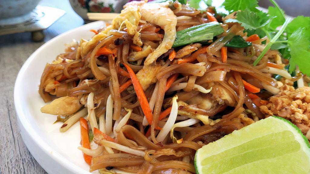 Pad Thai · Soft thin rice noodles sautéed with eggs, green onions, bean sprouts, fresh lime wedges, carrots and crushed peanuts.