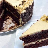 Cookie Dough Cake Slice · A chocolate devil's food cake layered with cookie dough filling and chocolate chips on the o...