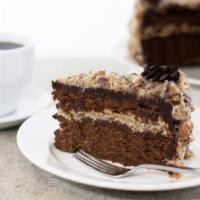 German Chocolate Cake Slice · Layers of chocolate cake are stacked with a pecan and shredded coconut icing. The cake is th...