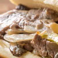 Steak And Cheese · Tender Ribeye grilled with sautéed onion and green pepper, topped with mozzarella cheese on ...