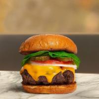 Cheese The Day Burger · American beef patty topped with melted cheese, buttered lettuce, tomato, onion, and pickles....