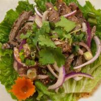 Num Tok Ⓖ · (Beef Salad) Grilled sliced beef tossed with roasted chili peppers, red onions, scallions, c...