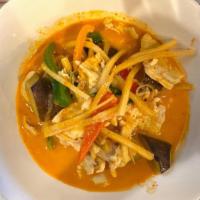 Red Curry Ⓖ · Fresh red chili curry paste and coconut milk with eggplants, bamboo shoots, bell peppers, an...
