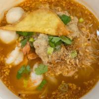 Tom Yum Noodle Soup · A classic Thai spicy and sour noodle soup with thin rice noodles, shrimp, ground chicken, fi...