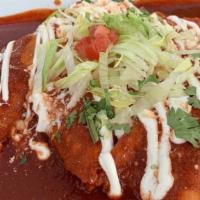 Mole Enchiladas · Three com tortillas smothered in mole sauce, filled with tinga chicken, topped with Mexican ...