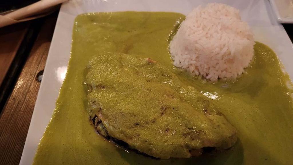Pollo Relleno · Chicken breast stuffed with queso fresco, finished with a creamy poblano pepper sauce and white rice.