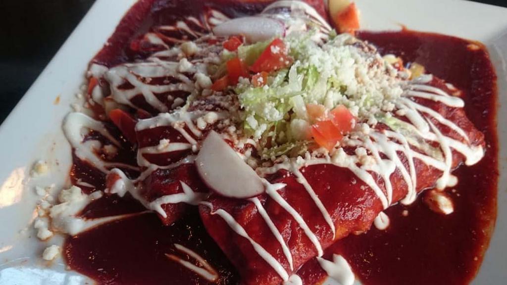 Enchiladas · Vegetarian. Three corn tortillas filled with carrots and potatoes, topped with a chile pasilla sauce, lettuce, Mexican cream, queso fresco, cilantro and tomatoes add chicken, steak or carnitas for 3.