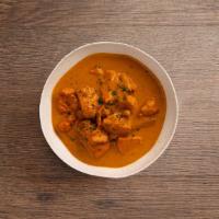 Butter Chicken (Makhani) · Boneless tandoori chicken cooked in a tomato and butter sauce.