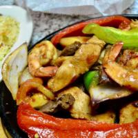 Fajitas Mixta · Beef, chicken and shrimp fajitas. Served with sour cream, guacamole, pico De gallo, rice, be...