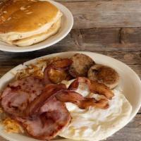 Bust Your Britches! · Two pancakes served with three eggs, hickory smoked bacon, sausage, or ham, and hash browns,...