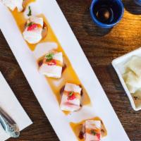 Hamachi Carpaccio · Slices of yellowtail served with tobiko, scallions spicy sesame oil, and sweet sauce.