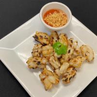 Pla Muk Yang (Bbq Squid) · BBQ squid served with spicy sauce and crushed peanuts.