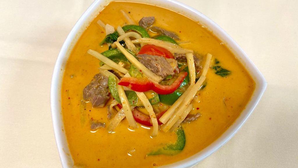 Gang Dang · Red curry and coconut milk with bamboo shoots, bell peppers, onions, lime leaves, and basil leaves.