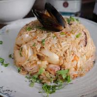 Marinero Rice · Fried rice cooked with shrimp, octopus, fish, and squid, topped with cilantro.