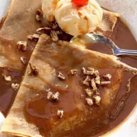 Crepas Con Cajeta · Soft crepes topped with cajeta and nuts, served with vanilla ice cream.