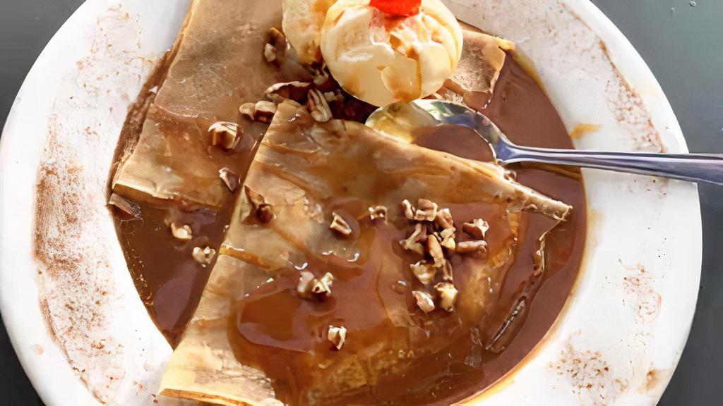 Crepas Con Cajeta · Soft crepes topped with cajeta and nuts, served with vanilla ice cream.