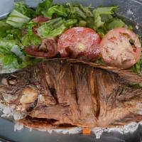 Mojarra Frita · Whole fish marinated and deep fried, served with homemade rice and fresh green salad.
