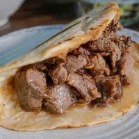 Grilled Beef Taco Plate · Marinated beef skirt steak, served on a homemade corn tortilla, with a thin layer of refried...