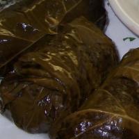 Dolmades · 5 homemade stuffed grape leaves,
 stuffed with beef, rice herbs and spices.