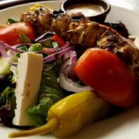 Chicken Souvlaki Salad · Tender skewered chicken breast seasoned to perfection on top of your choice of house, Caesar...