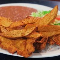 Milanesa De Pollo · Breaded thin sliced chicken breast and hand cut fries. Served with rice and refried beans, t...