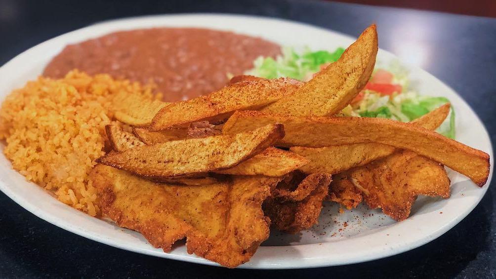 Milanesa De Pollo · Breaded thin sliced chicken breast and hand cut fries. Served with rice and refried beans, three hand made tortillas.
