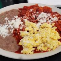 Chilaquiles Rojos · Fried tortilla, two eggs any style, topped with queso fresco. Beans on the side.