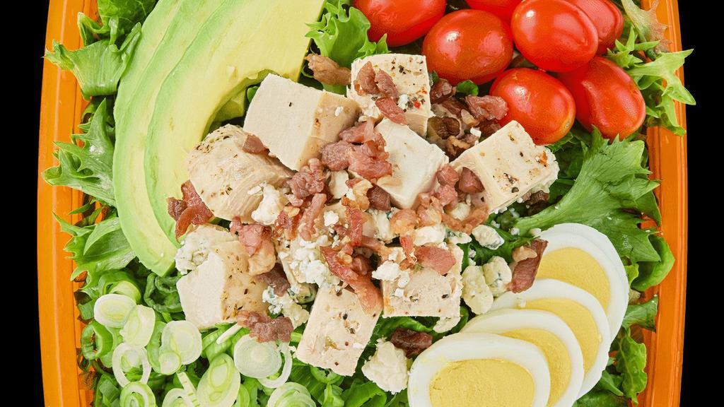 Cobb · Romaine, Mixed Greens, Tomatoes, Avocado, Bacon, Hard Boiled Egg, Red Onions, Shredded Cheese, and chicken. Paired with Creamy Blue Cheese Dressing  or Ranch