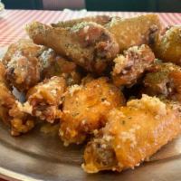 Butter Garlic Parmesan Wings · Crispy chicken wings tossed in butter, fresh garlic, and topped with grated Parmesan.