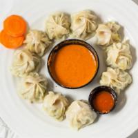 The Original (Steamed) Chicken Mo:Mo · Ten pieces. Steamed dumplings filled with ground chicken. Served with tomato-sesame seed sau...