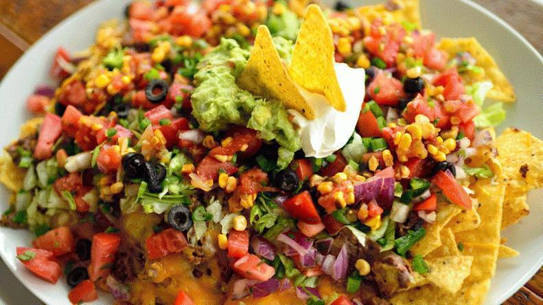 Supreme Nachos · Tortilla chips, queso, sour cream, salsa, and guacamole, served with your choice of protein.