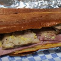 Honey Cuban Sandwich · Cuban style roasted pork, ham, Swiss cheese, pickles, mayo, mustard and real honey on the to...