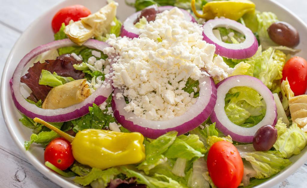 Greek Salad · Mixed salad greens, tomato, onion, pepperoncini, and feta cheese served with house Italian dressing on the side.