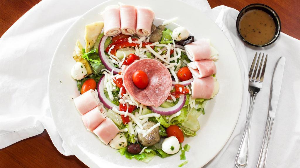 Antipasto Salad · Mixed salad greens, tomatoes, red onion, artichoke hearts, roasted red peppers, kalamata olives, fresh mozzarella, marinated button mushrooms, ham, salami, and provolone served with your choice of dressing.