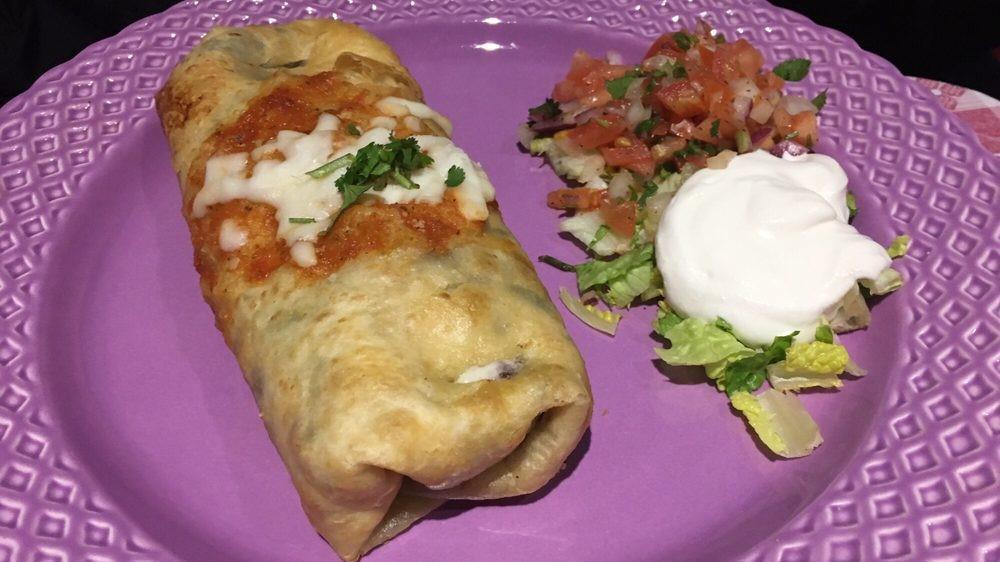 Chimichangas · A crispy chimichanga filled with rice, beans, cheese and served with sour cream and salad.