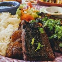 Mi Costillita · Beef short ribs marinated with Barbecue Sauce & seasoned with special herbs. Served with whi...