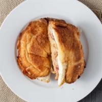 Breakfast · Yellow egg served on a fresh croissant. Includes cheese and your choice of ham, bacon, turke...