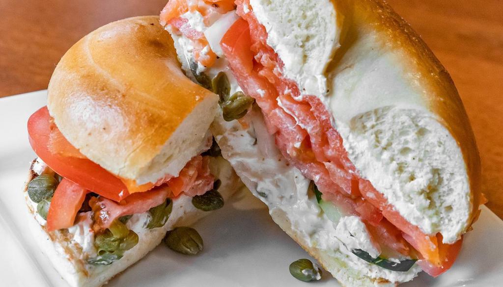 Lox Smoked Salmon Sandwich · 2 farm fresh eggs, smoked salmon, cream cheese, capers, red onions, tomato, cukes, on a toasted plain bagel.