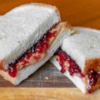 Pb & J Sandwich · Creamy peanut butter and jelly (choice of grape or strawberry) on white bread.