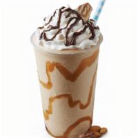 Snickers Shake · Caramel swirl, Snickers®, and Sweet Cream Ice Cream topped with whipped cream, Hershey’s® ch...