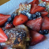 French Toast Sticks · Mascarpone and jelly filled french toast sticks topped with powdered sugar and fresh fruit.