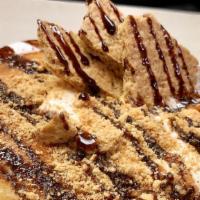 Gimme S'More · Three gooey chocolate chip pancakes topped with toasted marshmallow and crumbled graham crac...