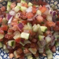 Jerusalem Salad · Diced tomatoes, onion, cucumber, chill pepper, lemon, mint, olive oil, and sumac.